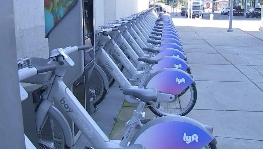 Bikeshare station full of the same type of gray bike. Bikeshare station full of the same type of gray bike.