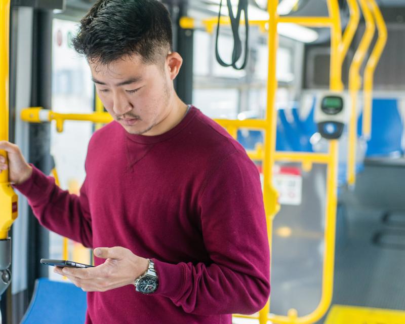 guy with phone buying muni fare