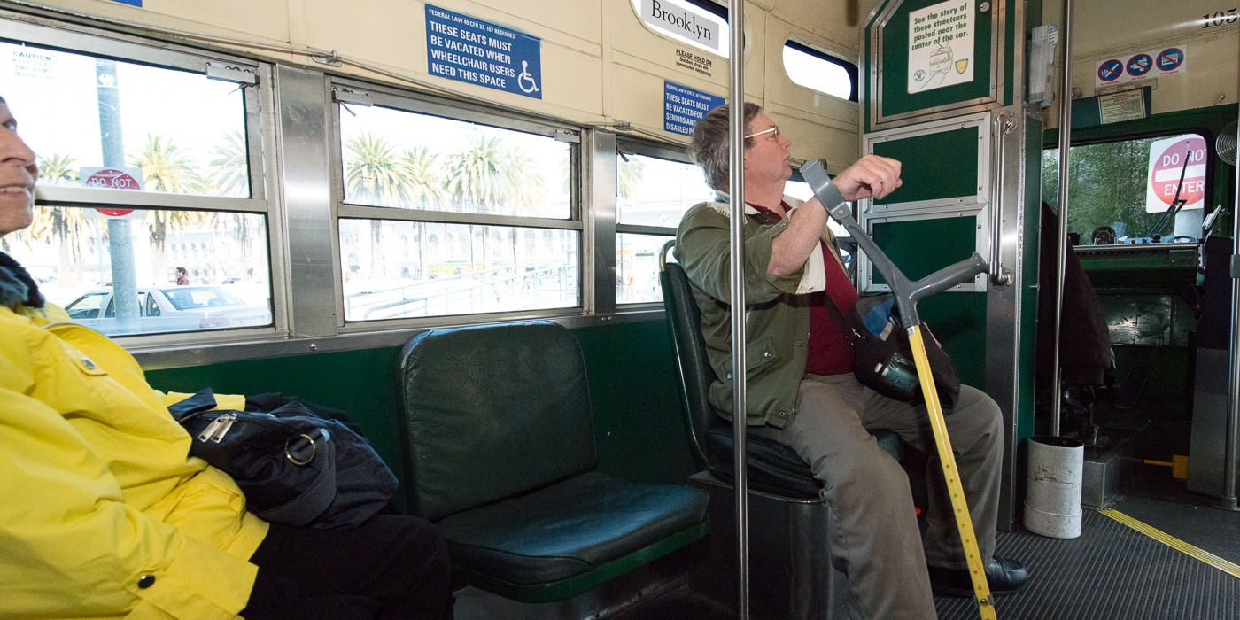 Passenger in a priority seating area on a PCC